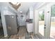 Bright kitchen with stainless steel appliances, white cabinets, and a door to the backyard at 881 Cedar Cir, Tavares, FL 32778