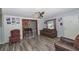 Cozy living room with hardwood floors, ceiling fan, comfortable furnishings, and plenty of natural light at 881 Cedar Cir, Tavares, FL 32778