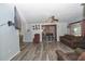 Spacious living room with a large TV, comfy seating, and modern flooring at 881 Cedar Cir, Tavares, FL 32778