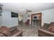 Comfortable living room featuring hard wood floors, warm paint colors, and an attached dining room at 881 Cedar Cir, Tavares, FL 32778
