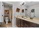 Bathroom features double vanity with dark wood cabinets and neutral decor at 888 Wakulla Ln, Winter Springs, FL 32708