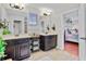 Bathroom featuring double vanities, tile floors, decor, and modern lighting at 888 Wakulla Ln, Winter Springs, FL 32708