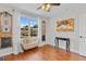 Bedroom featuring wood floors, a large window, and stylish decor at 888 Wakulla Ln, Winter Springs, FL 32708
