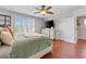 Bright bedroom with a ceiling fan, TV, window with shutters and hardwood flooring at 888 Wakulla Ln, Winter Springs, FL 32708