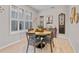 Cozy dining room featuring stylish decor and a large window, with seating for four around a round table at 888 Wakulla Ln, Winter Springs, FL 32708