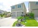 Two-story home with a double garage, wide driveway and colorful landscaping at 888 Wakulla Ln, Winter Springs, FL 32708