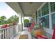 Charming front porch with red rocking chairs, greenery, and a decorative rooster figure at 888 Wakulla Ln, Winter Springs, FL 32708