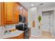 Bright kitchen featuring stainless appliances, wood cabinetry, and a breakfast bar with granite countertops at 888 Wakulla Ln, Winter Springs, FL 32708