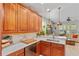 Modern kitchen with granite countertops, stainless steel appliances, and warm wooden cabinetry at 888 Wakulla Ln, Winter Springs, FL 32708
