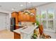 Bright kitchen featuring stainless appliances, wood cabinetry, and a breakfast bar with granite countertops at 888 Wakulla Ln, Winter Springs, FL 32708