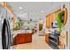 Open-concept kitchen featuring granite counters, stainless appliances, and seamless flow to the living area at 888 Wakulla Ln, Winter Springs, FL 32708