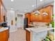 Bright kitchen featuring stainless appliances, wood cabinetry, and a breakfast bar with granite countertops at 888 Wakulla Ln, Winter Springs, FL 32708