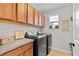 Well-organized laundry room with modern appliances, cabinets, and natural light at 888 Wakulla Ln, Winter Springs, FL 32708