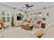 Bright and airy living room featuring neutral tones, large windows, and stylish furnishings at 888 Wakulla Ln, Winter Springs, FL 32708