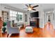 Living room featuring hardwood floors, a corner fireplace, and a large window offering natural light at 888 Wakulla Ln, Winter Springs, FL 32708