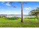 Spacious backyard featuring mature trees and a picturesque lake view with a private dock at 942 Beach Breeze Dr, Orlando, FL 32835