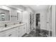 A bathroom with double vanity, a shower, and a unique set of sliding doors to the closet at 942 Beach Breeze Dr, Orlando, FL 32835