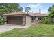 Charming single-story home with a two-car garage, well-maintained lawn, and inviting curb appeal at 942 Beach Breeze Dr, Orlando, FL 32835