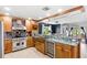 Gourmet kitchen boasts stainless steel appliances, custom cabinets, and counter seating at 942 Beach Breeze Dr, Orlando, FL 32835