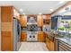 Well-appointed kitchen featuring stainless steel appliances, custom cabinetry, and a wine refrigerator at 942 Beach Breeze Dr, Orlando, FL 32835