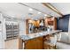 Elegant kitchen with stainless steel appliances, custom cabinets, granite countertops, and breakfast bar at 942 Beach Breeze Dr, Orlando, FL 32835
