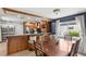 Charming kitchen with wood cabinets, stainless steel appliances, and breakfast bar seating at 942 Beach Breeze Dr, Orlando, FL 32835