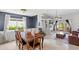 Open concept living and dining area with vaulted ceilings, fireplace, and sliding doors to the patio at 942 Beach Breeze Dr, Orlando, FL 32835