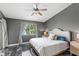 A comfortable bedroom with a window view and luxurious marble flooring at 942 Beach Breeze Dr, Orlando, FL 32835
