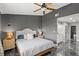 A comfortable bedroom with an en-suite bathroom and luxurious marble flooring at 942 Beach Breeze Dr, Orlando, FL 32835