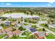 Expansive aerial view of a residential neighborhood surrounding a calm lake on a sunny day at 1028 Ocala Woods Ln, Orlando, FL 32824
