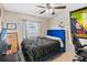Cozy bedroom with bright blue bed frame, tile floors, and natural light at 1028 Ocala Woods Ln, Orlando, FL 32824
