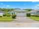 Charming single-story home with a two-car garage, well-manicured lawn, and lush landscaping at 1028 Ocala Woods Ln, Orlando, FL 32824