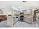 Contemporary kitchen equipped with stainless steel appliances, sleek gray cabinetry and open floor plan for easy entertaining at 1028 Ocala Woods Ln, Orlando, FL 32824
