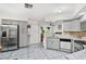 Modern kitchen featuring gray cabinets, granite countertops, stainless steel appliances, and stylish tile flooring at 1028 Ocala Woods Ln, Orlando, FL 32824