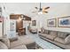 Spacious living room with tile flooring, vaulted ceiling, and comfortable seating arrangements at 1028 Ocala Woods Ln, Orlando, FL 32824