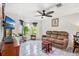 Sunlit living room with tile flooring, ceiling fan and a bay window offering a warm and inviting atmosphere at 1028 Ocala Woods Ln, Orlando, FL 32824