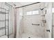 Modern shower featuring white tile, window and shower head at 1028 Ocala Woods Ln, Orlando, FL 32824