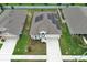 Aerial view of house featuring solar panels on roof, well-maintained lawn, and proximity to neighboring homes at 1061 Citrus Landings Blvd, Davenport, FL 33837