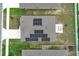 Birds-eye view of home's roof fitted with solar panels, featuring a fire pit, yard and fence at 1061 Citrus Landings Blvd, Davenport, FL 33837