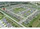 Expansive aerial view of a residential community featuring well-maintained homes and green spaces at 1061 Citrus Landings Blvd, Davenport, FL 33837