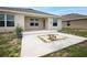 Home's back exterior featuring a cozy patio and fire pit area for outdoor gatherings at 1061 Citrus Landings Blvd, Davenport, FL 33837