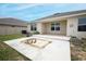 The exterior back of the house has a patio and fire pit at 1061 Citrus Landings Blvd, Davenport, FL 33837