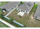 An aerial view of the backyard featuring a fire pit area, a patio and fencing at 1061 Citrus Landings Blvd, Davenport, FL 33837