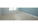 A simple bedroom featuring neutral carpet, window, and base molding at 1061 Citrus Landings Blvd, Davenport, FL 33837