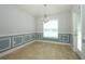 Dining room featuring decorative wainscotting, tile floors and a modern chandelier at 1061 Citrus Landings Blvd, Davenport, FL 33837