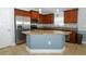 Gourmet kitchen featuring stainless steel appliances, granite countertops, and a center island with seating at 1061 Citrus Landings Blvd, Davenport, FL 33837