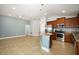 Open kitchen and living area with granite countertops, stainless appliances, and tile flooring at 1061 Citrus Landings Blvd, Davenport, FL 33837