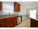 Well-equipped kitchen with stainless steel appliances, granite countertops and backsplash and warm wood cabinets at 1061 Citrus Landings Blvd, Davenport, FL 33837