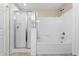 Bright bathroom showcasing a glass enclosed shower and separate soaking tub with tiled walls at 1101 Vintage Village Ln # 101, Ocoee, FL 34761