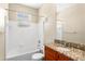 Bathroom featuring vanity with granite counters and a bathtub with white tile at 1101 Vintage Village Ln # 101, Ocoee, FL 34761